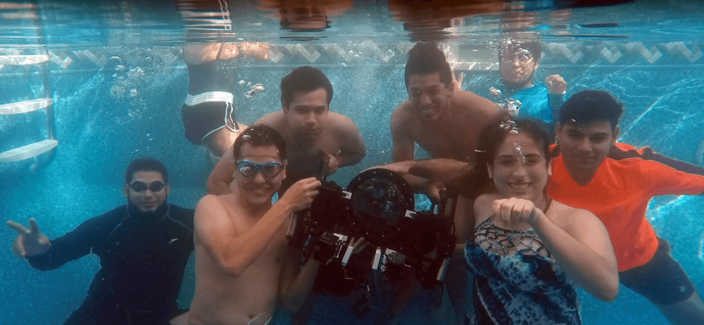 A student team (and their ROV) at an underwater robotics competition.