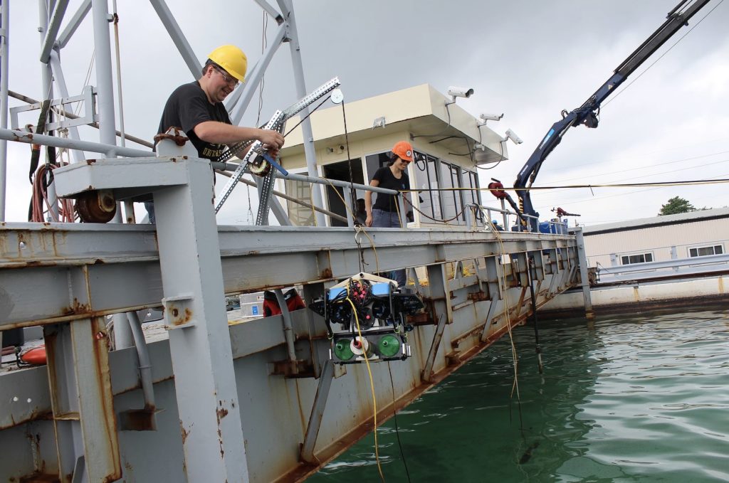 Allison Chua and her team deploying their <em>BlueROV2</em>. (Credit: Tom Coolbaugh)