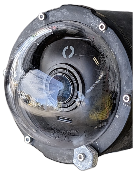 outside view of the camera housed in an enclosure with a clear dome